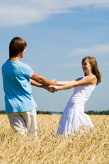 Portrait of cheerful girl and guy looking at one another