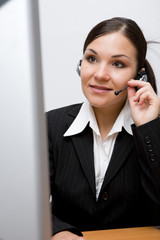 happy businesswoman at desk with headphone