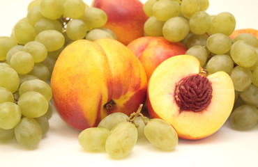 Bright, ripe fruit - grapes and nectarines. Object over white