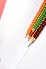 Close-up of color pencils and agenda