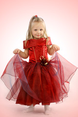 Portrait of the beautiful girl in a red dress