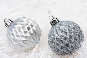 Silver glass balls on white garland background