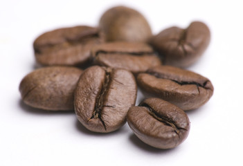 Close up of group of coffee beans isolated on white background