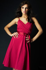 Fototapeta premium girl wearing a nice ping dress on black background