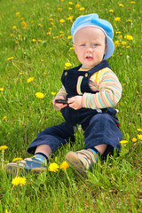 child sits on grass