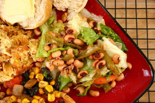 Black Eye Pea Salad In Plate With Baked Squash And Roll.