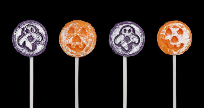 Four halloween suckers isolated on a black background
