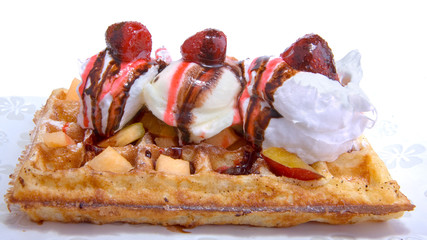 Waffle with vanilla ice cream coating strawberry and cocollate..