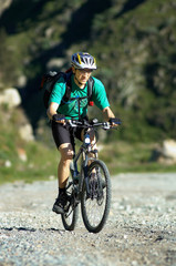 Fototapeta premium Mountain biker on country road