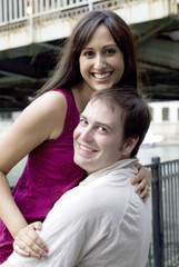 Young man and young woman posing with her