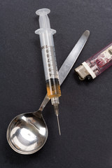 Syringe, spoon and lighter, concept of addiction