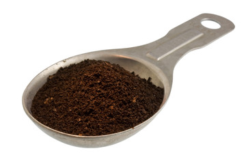 Measuring tablespoon of ground coffe, dark French roast