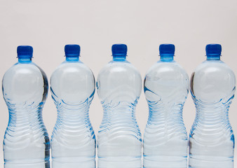 bottles of clear water with blue cap