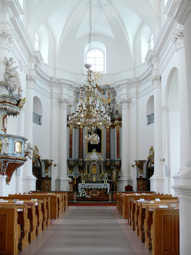 interior of an empty church with rows of benches