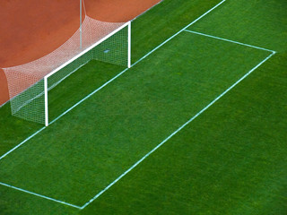 Empty goal gates on a green grass on a soccer stadium