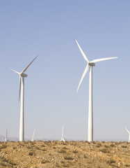 Fototapeta premium Blue Sky Smoke Free behind Electric Wind Mill Turbine