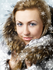 Young women under snow wearing a winter jacket