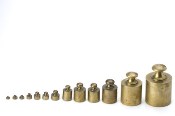 brass weights on white background