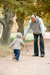 father and son in autumn park