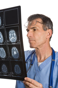 Physician reading and reviewing a MRI brain scan