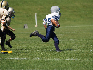 young american football player running for a touchdown