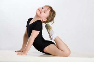 Little girl making sport exercises