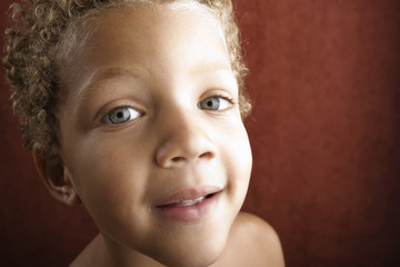 Portrait of a handsome young boy with curly hair