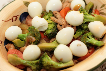 close up of broccoli with quail eggs .