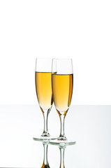 Two wine glasses on the reflective background