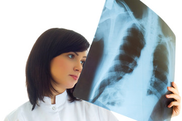 Female doctor looking at x-ray image on white