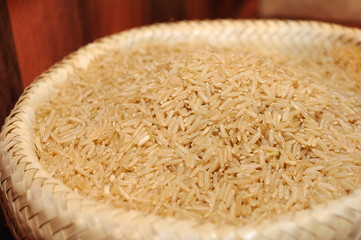 Close up of raw brown rice in sack