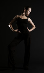 young dancer posing over dark background