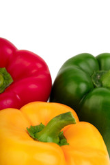 Three bell peppers - red, yellow and green on a white background
