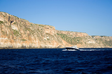The motorboat drives fast on the sea.