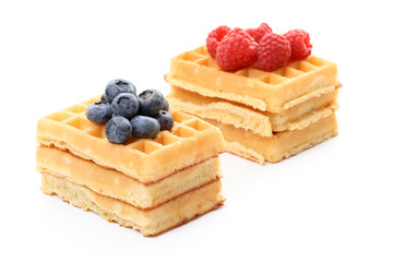 delicious waffles with various fruits isolated on white