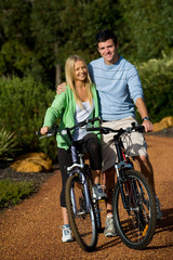 Fototapeta premium A young couple on bicycles in the countryside