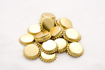 Pile of golden beer bottle caps