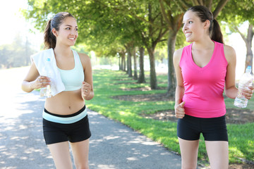 Two pretty women sisters  jogging in the park