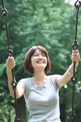 young woman rides on the swing