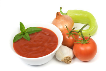 Tomato soup with vegetables isolated on white