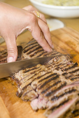 Delicious freshly prepared seared sirloin on a wooden board.