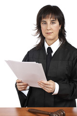 A female judge in a courtroom reading the verdict. Shallow DOF