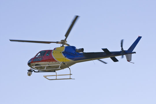A helicopter with a camera. A motion blur on rotor blades.