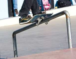 Skateboarder on a fence railing