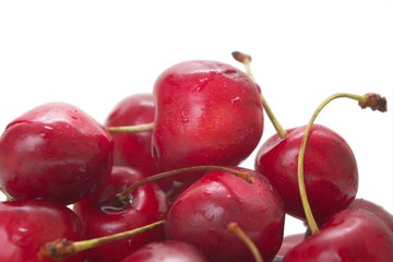 heap of sweet cherries on white