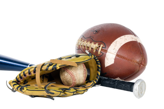 A well used football, baseball and bat. Isolated on white.