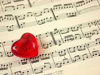 Close up of a music score and a red heart