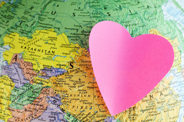 Earth globe and paper heart