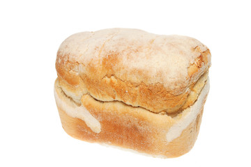 Freshly baked crusty farmhouse loaf of bread on white