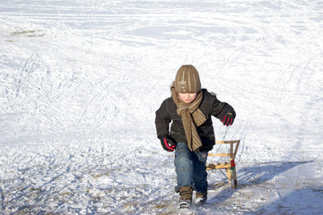 Boy with the sledge in suny winter day - 9451602